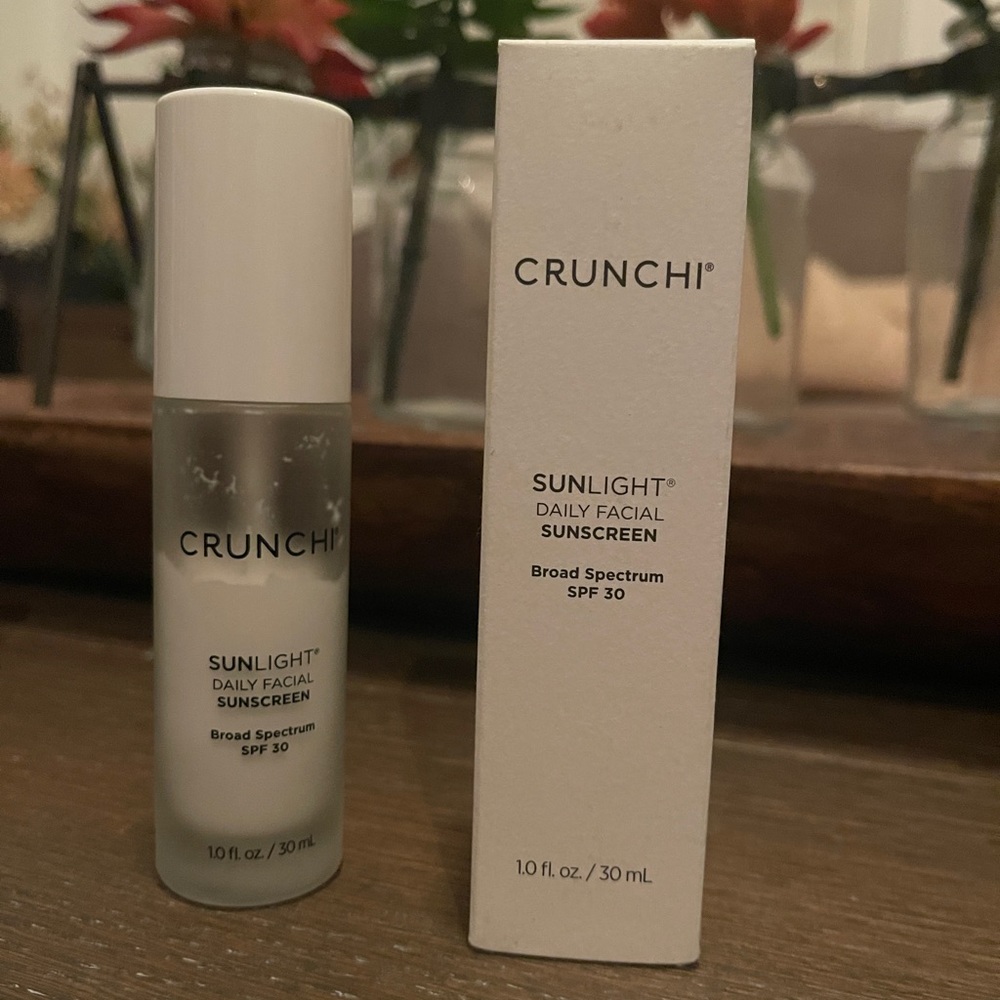 2 Crunchi Sunlight Daily Facial Sunscreen. 1 new, 1 just over half full.